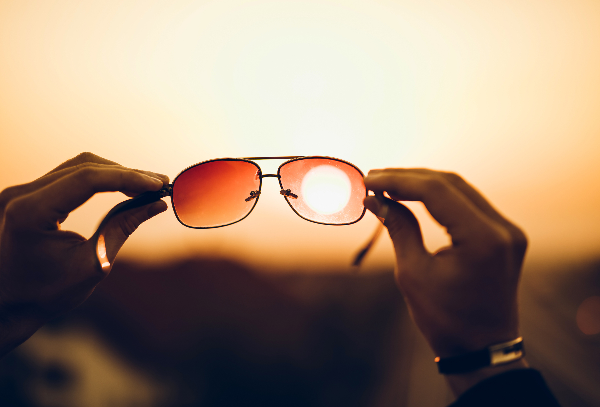 Holding sunglasses